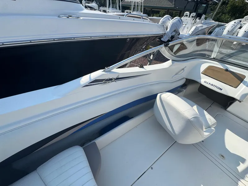Slide: The Image of 2003 Glastron SX 195 boat interior with white seating and sleek design. - 20