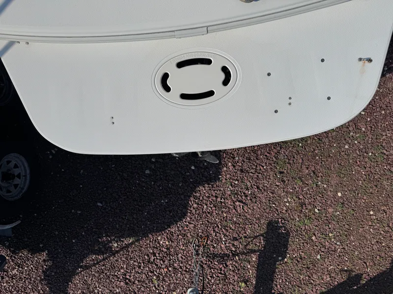 Slide: The Image of 2003 Glastron SX 195 boat stern on gravel surface, showcasing swim platform. - 21