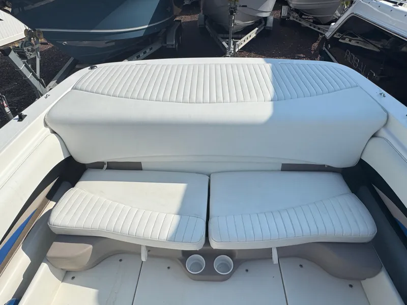 Slide: The Image of 2003 Glastron SX 195 boat interior with white cushioned seating and cup holders. - 5