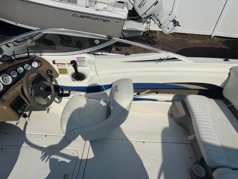 Slide: The Image of 2003 Glastron SX 195 boat interior with steering wheel and seating. - 7