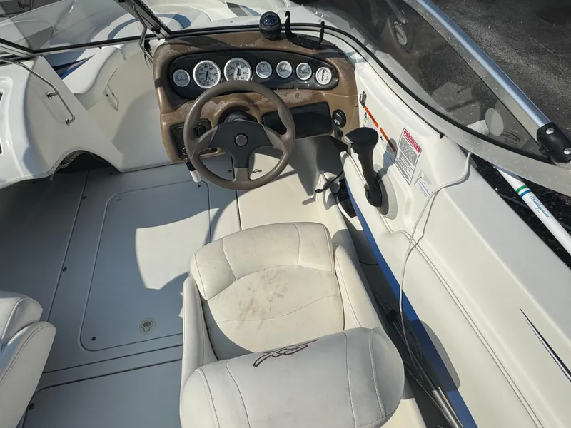 Slide: The Image of 2003 Glastron SX 195 boat interior with steering wheel and dashboard controls. - 8