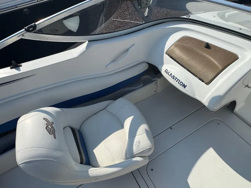 Slide: The Image of 2003 Glastron SX 195 boat interior with white seating and dashboard. - 9