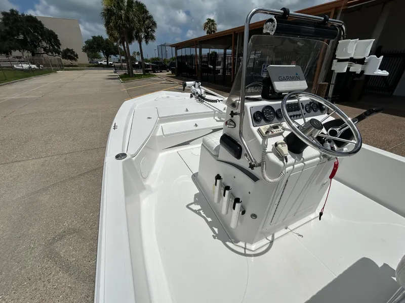 Slide: The Image of 2012 Blue Wave 1900 STL boat with Garmin navigation, parked outdoors under a cloudy sky. - 11