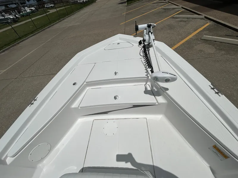 Slide: The Image of 2012 Blue Wave 1900 STL boat deck with trolling motor, parked on concrete. - 14