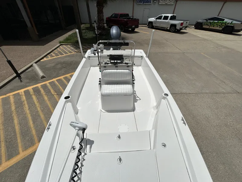 Slide: The Image of 2012 Blue Wave 1900 STL boat interior with seating and controls, parked in a lot. - 15