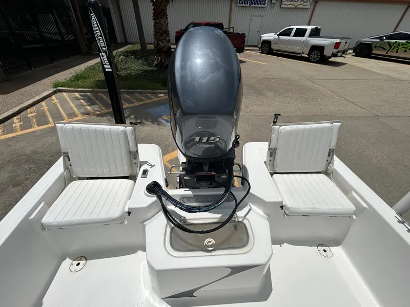 Slide: The Image of 2012 Blue Wave 1900 STL boat with Yamaha 115 engine, parked outdoors. - 8