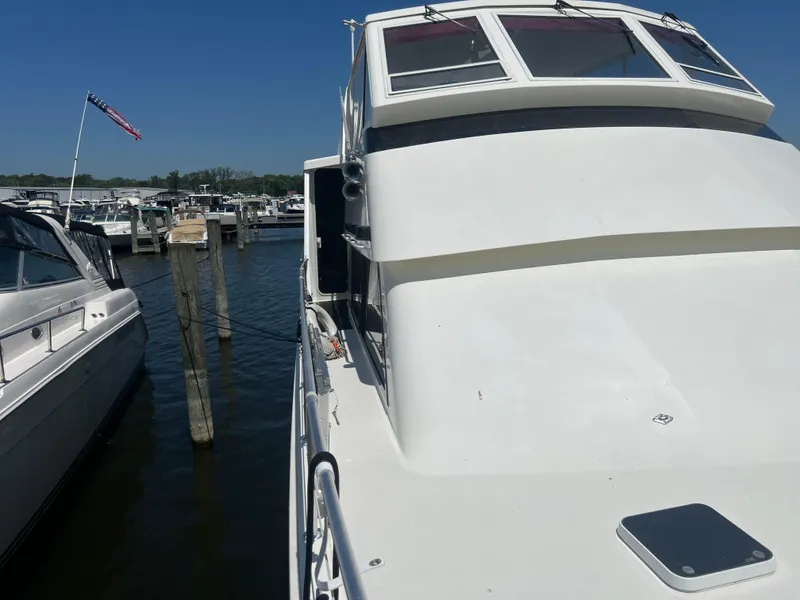 Slide: The Image of 1995 Viking Sports Yacht docked at marina under clear blue sky. - 11