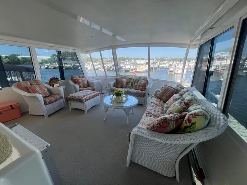 Slide: The Image of Luxurious 1995 Viking Sports Yacht interior with wicker furniture and marina view. - 13