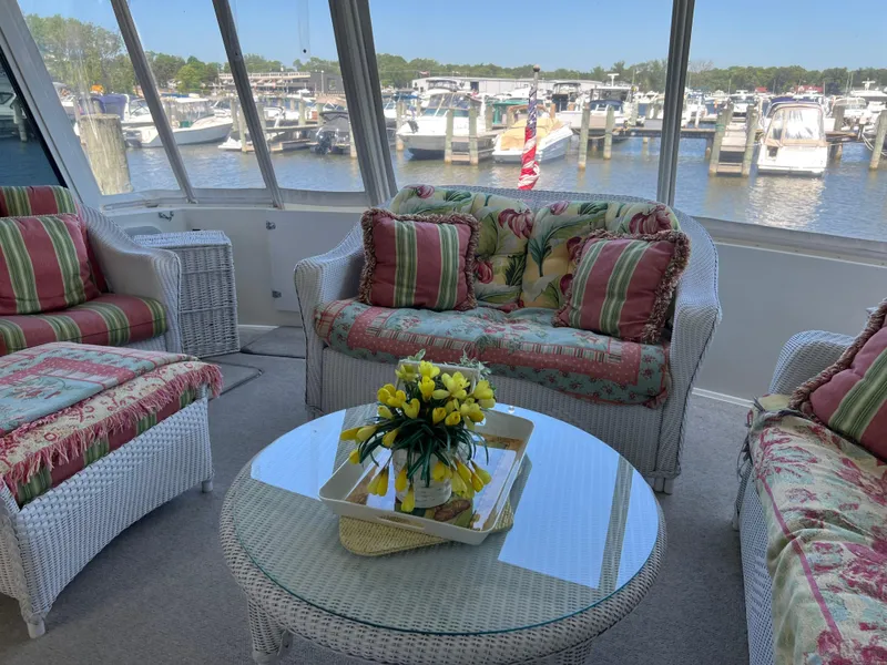 Slide: The Image of Cozy interior of a 1995 Viking Sports Yacht with wicker furniture and marina view. - 15