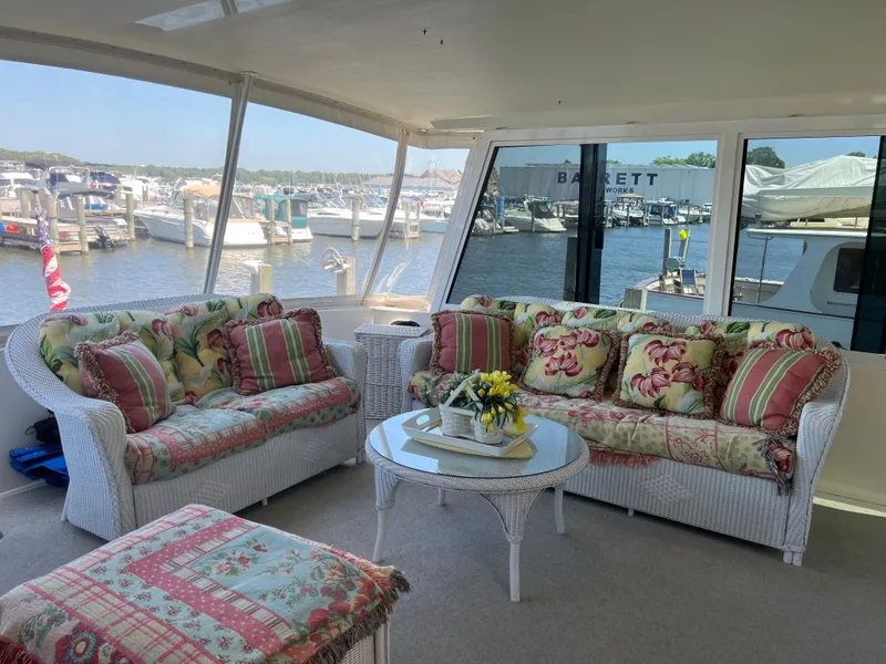 Slide: The Image of Luxurious 1995 Viking Sports Yacht interior with floral cushions and marina view. - 16