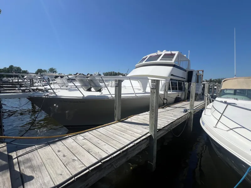 Slide: The Image of 1995 Viking Sports Yacht docked at marina under clear blue sky. - 2
