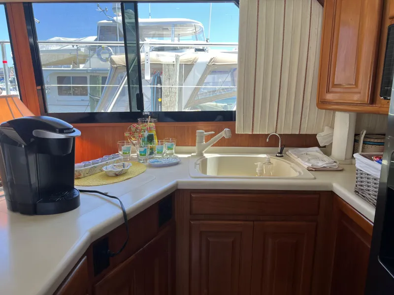Slide: The Image of Interior of 1995 Viking Sports Yacht kitchen with sink, coffee maker, and window view. - 20