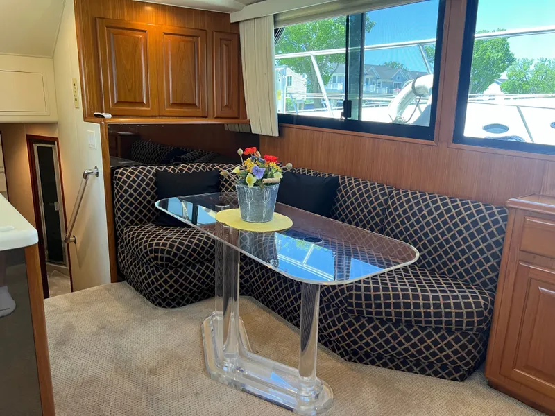 Slide: The Image of Interior of 1995 Viking Sports Yacht with elegant seating and glass table. - 23