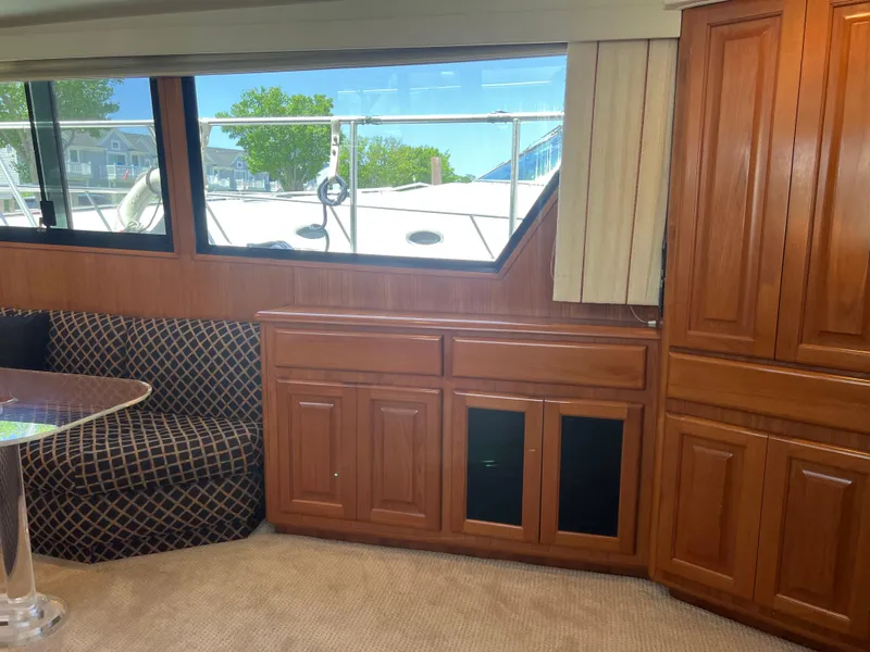 Slide: The Image of Interior of a 1995 Viking Sports Yacht with wood cabinetry and patterned seating. - 26
