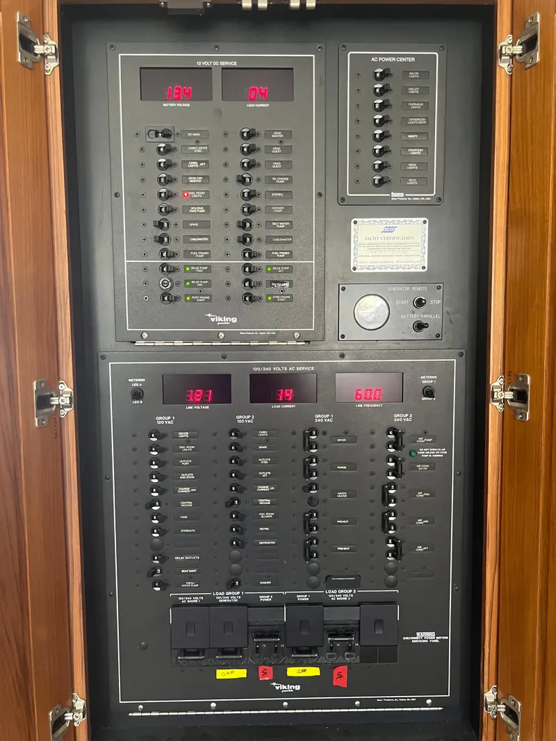 Slide: The Image of Electrical control panel inside a 1995 Viking Sports Yacht, featuring various switches and displays. - 27