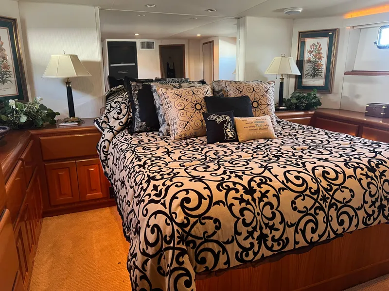 Slide: The Image of Luxurious bedroom interior of a 1995 Viking Sports Yacht with elegant bedding and decor. - 29