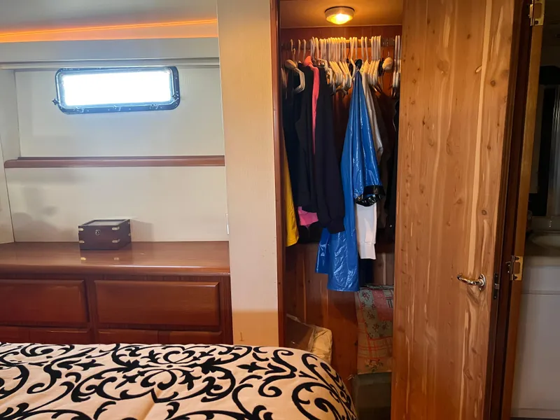 Slide: The Image of Cozy cabin interior of 1995 Viking Sports Yacht with closet and window. - 32