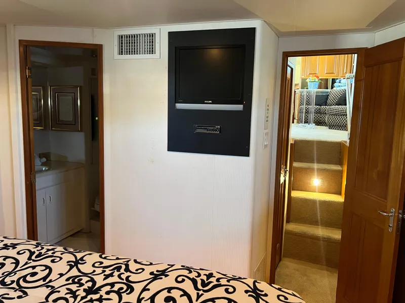 Slide: The Image of Interior of a 1995 Viking Sports Yacht with TV, stairs, and bathroom. - 34