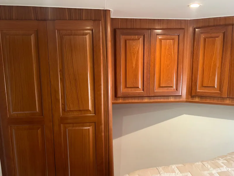 Slide: The Image of Luxurious wooden cabinetry inside a 1995 Viking Sports Yacht, showcasing elegant craftsmanship. - 39