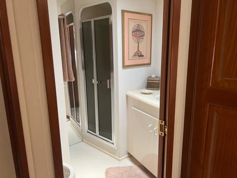 Slide: The Image of Bathroom interior of a 1995 Viking Sports Yacht with shower and framed artwork. - 41