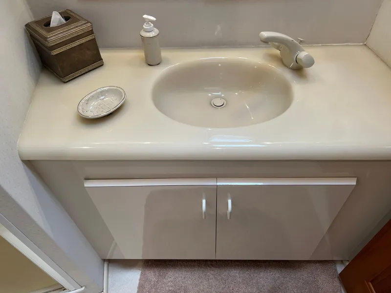 Slide: The Image of Bathroom sink area on a 1995 Viking Sports Yacht with soap dispenser and tissue box. - 47