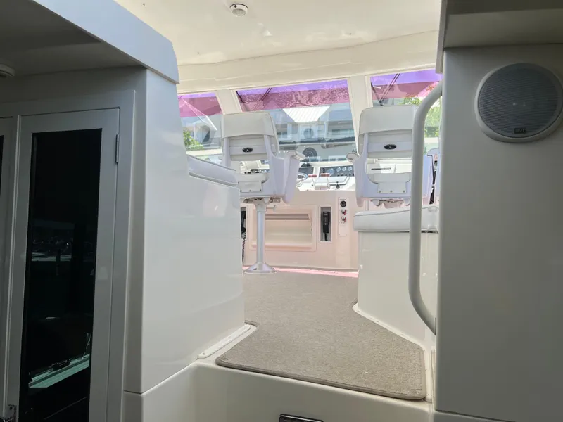 Slide: The Image of Interior view of a 1995 Viking Sports Yacht cockpit with white seating and control panel. - 48