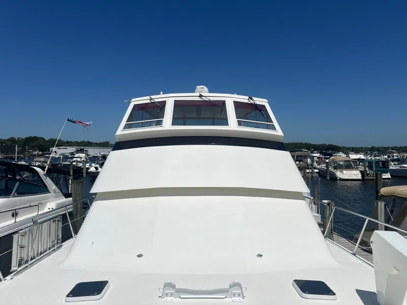 Slide: The Image of 1995 Viking Sports Yacht docked at marina under clear blue sky. - 6