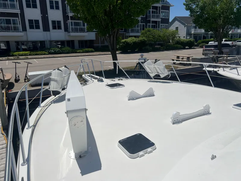 Slide: The Image of 1995 Viking Sports Yacht docked near residential buildings, showcasing its spacious deck. - 8