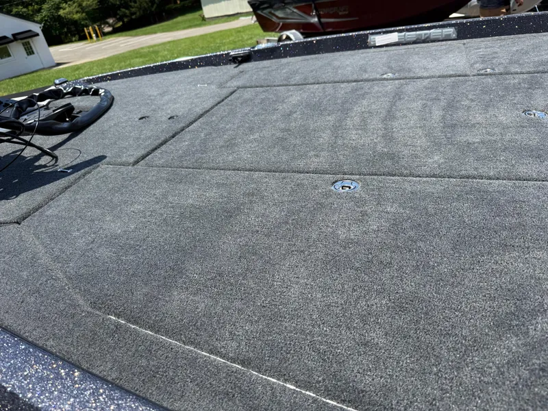 Slide: The Image of 2026 Skeeter ZXE20 boat deck with gray carpet and storage compartments. - 10