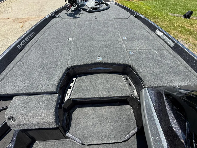 Slide: The Image of 2026 Skeeter ZXE20 boat deck with carpeted surface and storage compartments. - 12