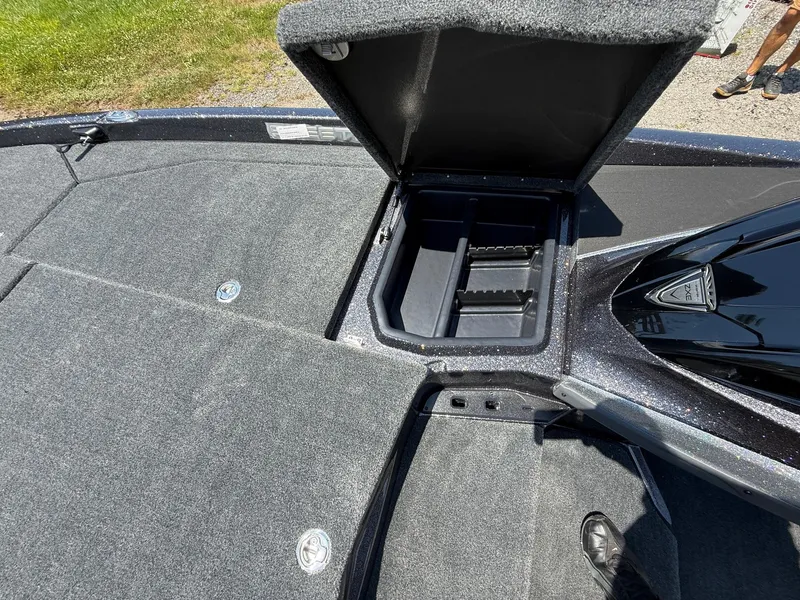 Slide: The Image of 2026 Skeeter ZXE20 boat deck with open storage compartment, gray carpet, and sleek design. - 14