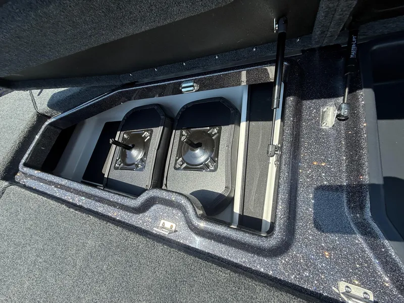 Slide: The Image of Storage compartment in 2026 Skeeter ZXE20 boat, featuring dual battery holders. - 15