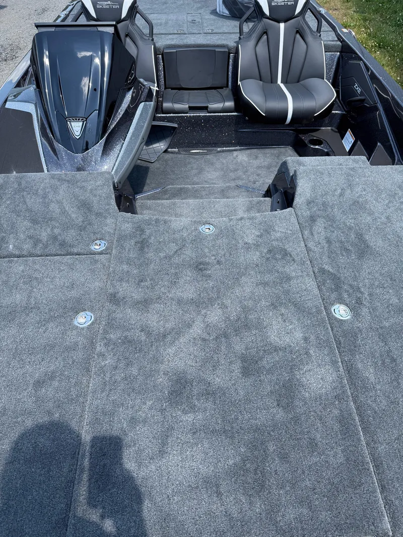 Slide: The Image of 2026 Skeeter ZXE20 boat interior with gray carpet and black seats. - 20