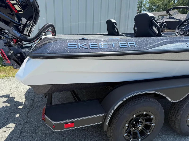 Slide: The Image of 2026 Skeeter ZXE20 boat with dual axle trailer, featuring sleek design and powerful engine. - 30
