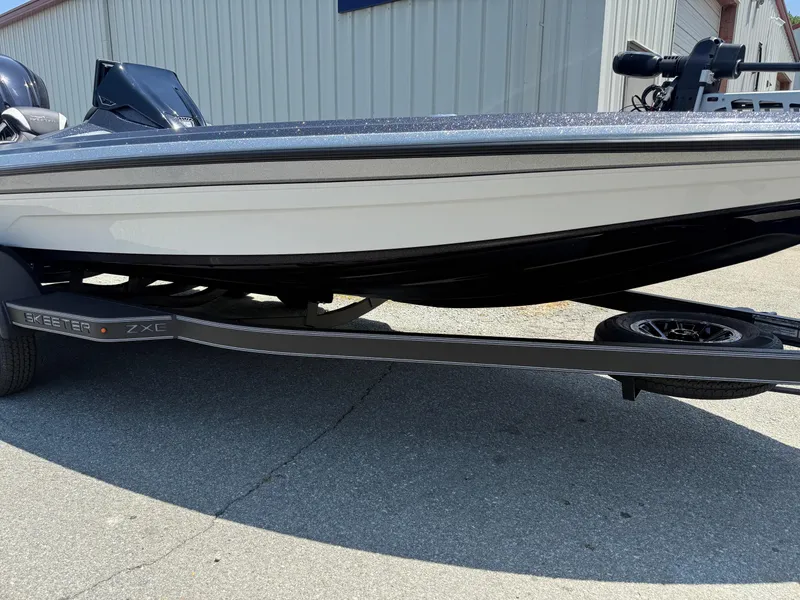 Slide: The Image of 2026 Skeeter ZXE20 boat on trailer, parked outside a building. - 31