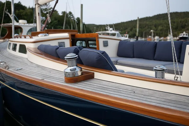 Slide: The Image of 2006 Morris M36 Daysailer with wooden deck and blue cushions, docked in a marina. - 13
