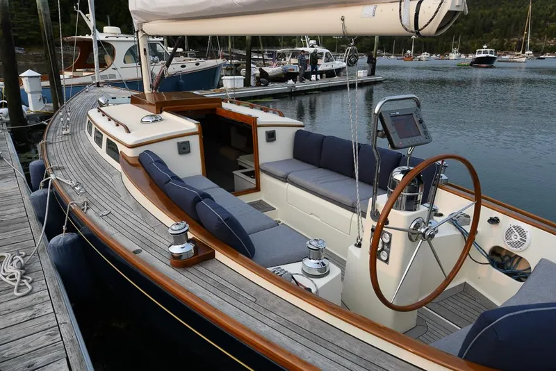 Slide: The Image of 2006 Morris M36 Daysailer docked, featuring elegant wooden deck and modern cockpit design. - 19