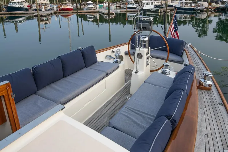 Slide: The Image of 2006 Morris M36 Daysailer with blue cushions, docked in a marina. - 23