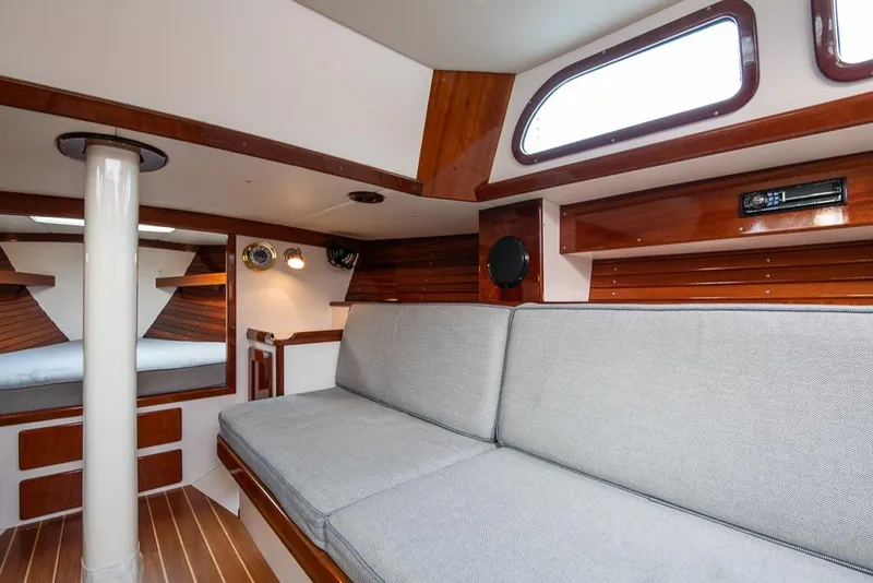 Slide: The Image of Interior of 2006 Morris M36 Daysailer with wooden accents and cushioned seating. - 33