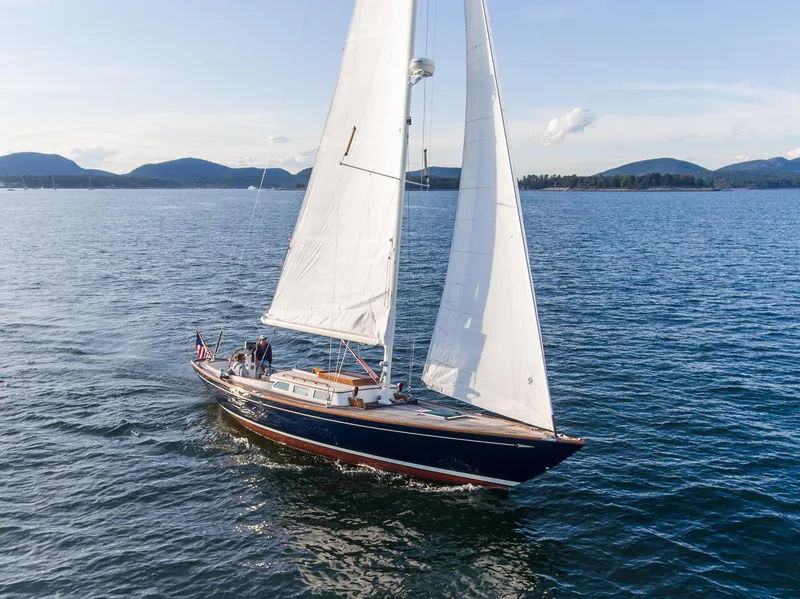 Slide: The Image of Sailing on open water, 2006 Morris M36 Daysailer with white sails and scenic mountain backdrop. - 4