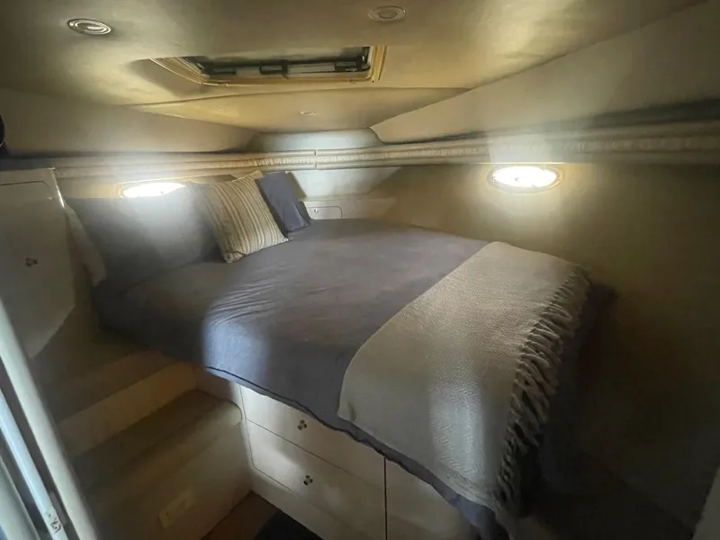 Slide: The Image of Cozy cabin interior of 1996 Regal Commodore 402 yacht with bed and porthole windows. - 13
