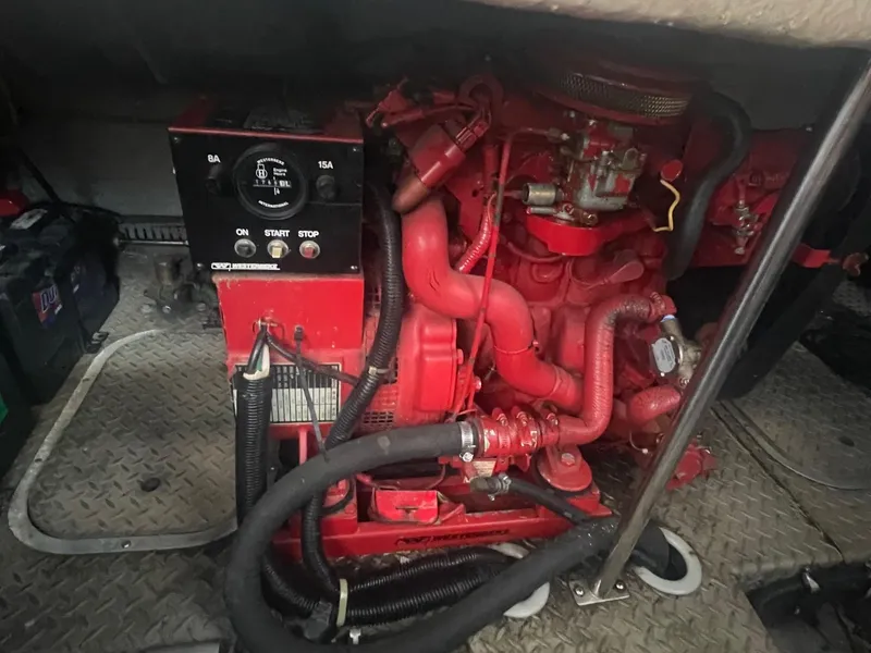 Slide: The Image of Engine compartment of a 1996 Regal Commodore 402 boat, featuring a red engine. - 19