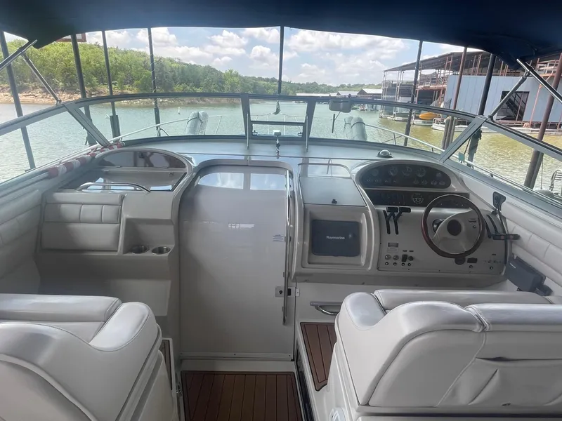 Slide: The Image of Interior view of a 1996 Regal Commodore 402 boat cockpit with steering wheel and controls. - 4