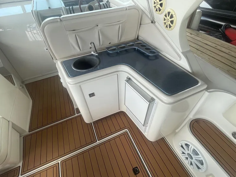 Slide: The Image of 1996 Regal Commodore 402 yacht interior with kitchenette and wood flooring. - 5