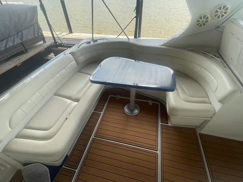 Slide: The Image of Luxurious seating area on 1996 Regal Commodore 402 yacht with wooden flooring and table. - 6