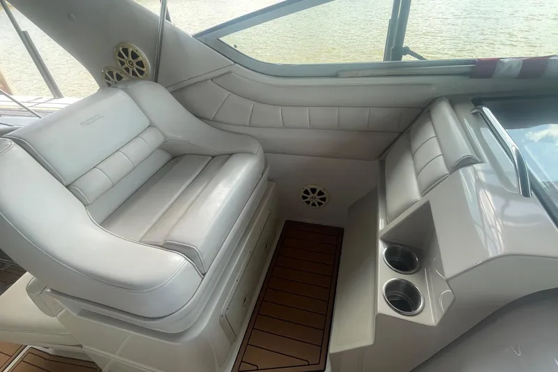 Slide: The Image of 1996 Regal Commodore 402 boat interior with white seating and cup holders. - 7