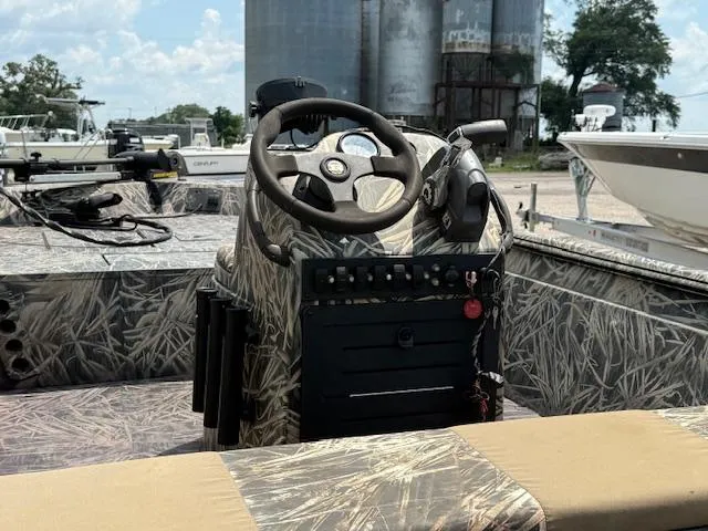 Slide: The Image of 2015 Ranger 1862 CC boat with camo design, featuring steering console and control panel. - 10