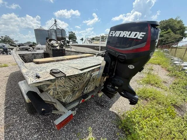 Slide: The Image of 2015 Ranger 1862 CC boat with Evinrude outboard motor on a trailer. - 9