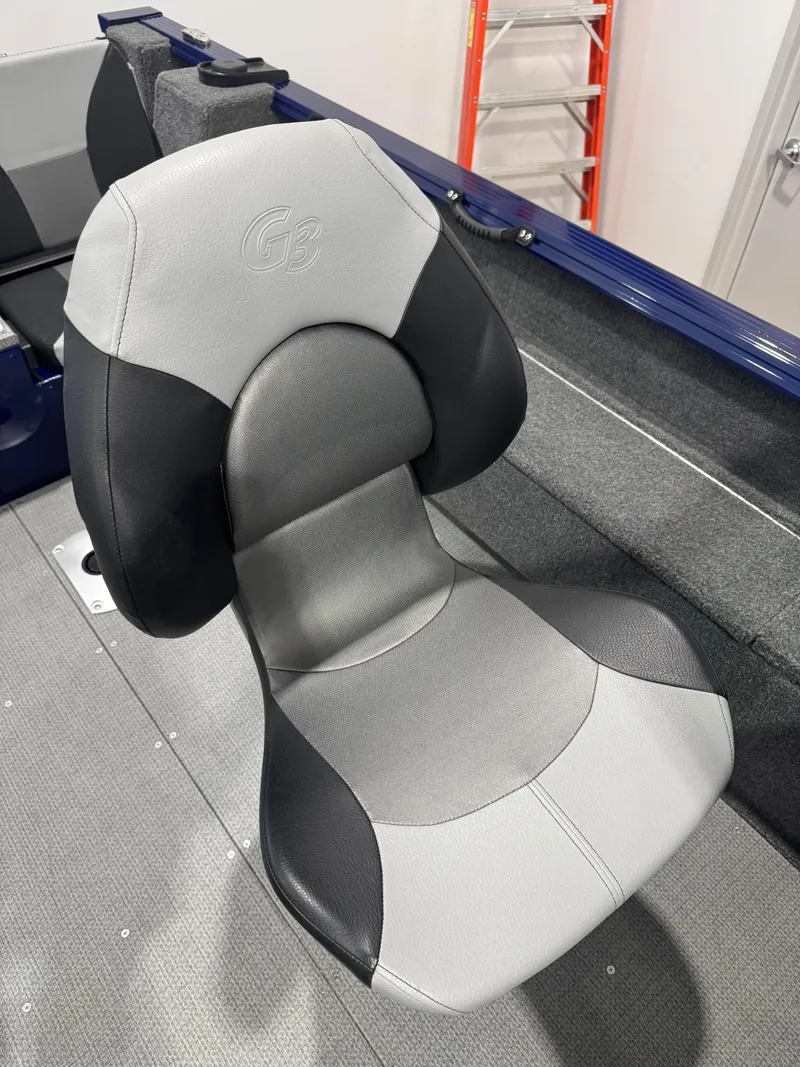 Slide: The Image of 2024 G3 AV18SF VINYL boat seat, gray and black design, in a marine setting. - 13