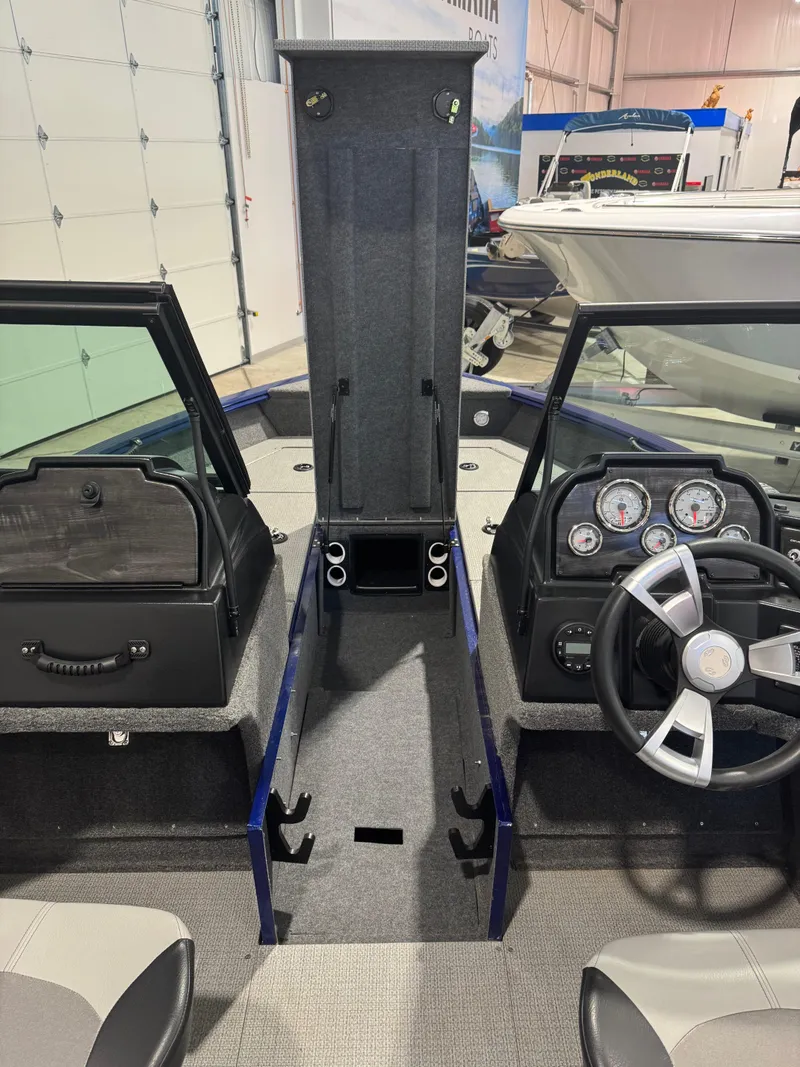 Slide: The Image of 2024 G3 AV18SF VINYL boat interior with steering wheel, gauges, and storage compartments. - 16